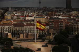 A Spanish flag flies at half staff, for the victims of the Germanwings passenger jet, in Madrid, Spain. Wed, March 25, 2015. | source: ECS Group