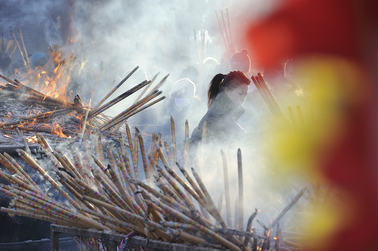 source: Tao Zhang/NurPhoto via Getty Images | Chinese worshippers light incense as they pray at the Dacheng Temple on Jan 28, 2017 in Qiqihar, China.